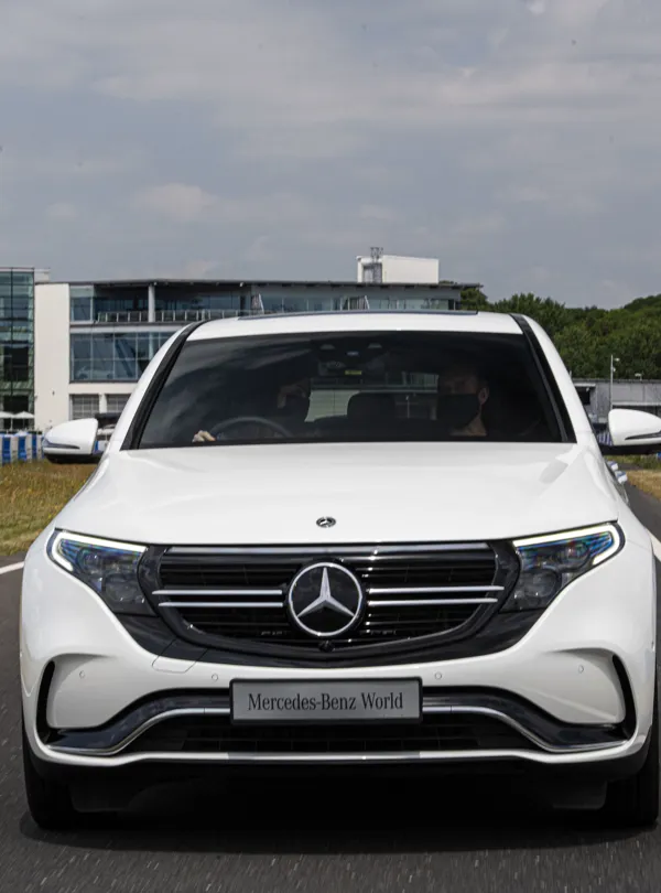 Corporate event setup at Mercedes-Benz World with professional lighting, seating arrangements, and presentation screens in a modern venue space.