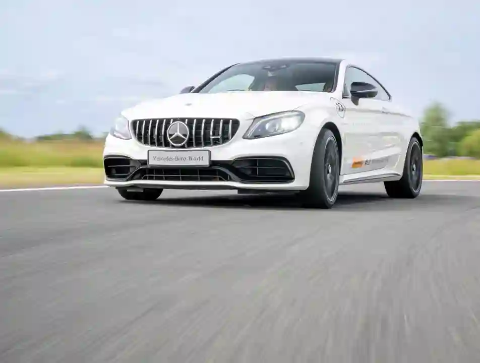Mercedes-AMG 63 in action on a dynamic driving track at Mercedes-Benz World during a high-performance one-hour experience.