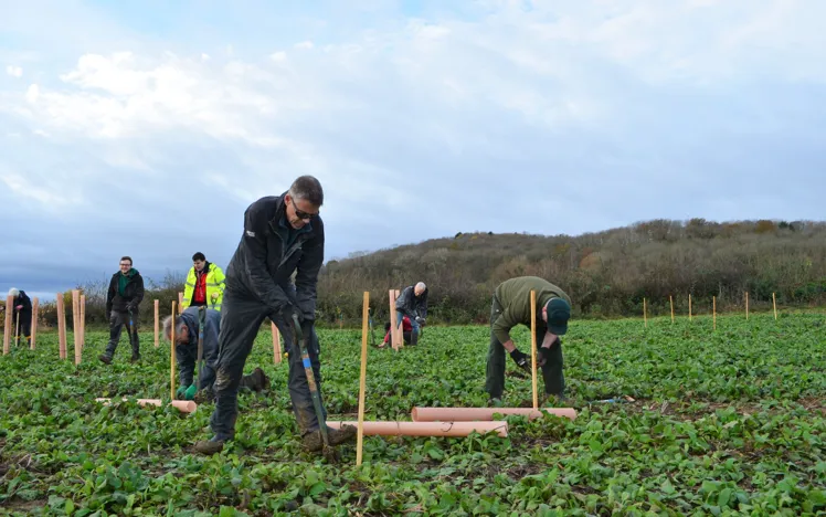 Pro Driver demonstrating high-speed performance in an AMG vehicle on the track at Mercedes-Benz World with motion blur effect.