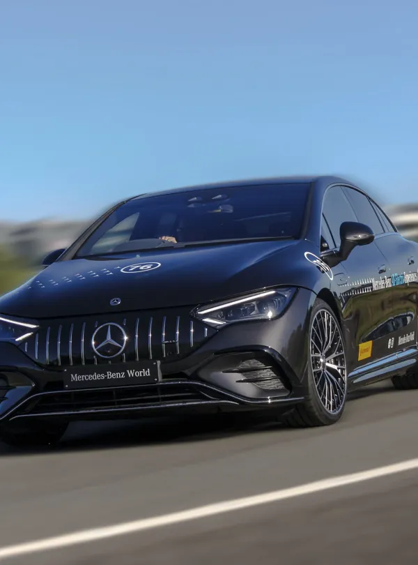 Mercedes-Benz EQE 53 on track at Mercedes-Benz World, celebrating the brand’s rich automotive heritage and design evolution.