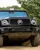 Passenger enjoying a thrilling 4x4 ride through rugged terrain at Mercedes-Benz World's Off-Road Circuit, showcasing vehicle capability and adventure.