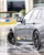 Close-up of a Mercedes-AMG vehicle drifting on a wet handling track at Mercedes-Benz World, showcasing precision control and performance in challenging conditions.